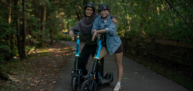 Two friends enjoying a ride on Evolve e-bike scooters