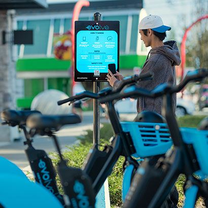 Man unlocking his Evolve e-scooter for a ride