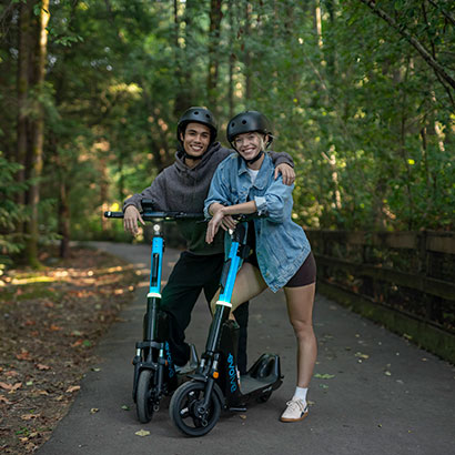 Friends posing on Evolve bikes in a park