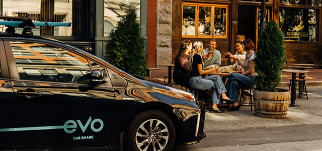 Evo parked in front of friends dining outdoors