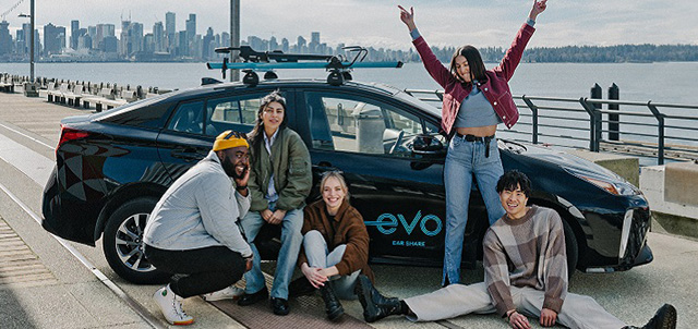 Friends in front of an Evo on a boardwalk